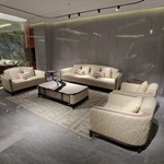 Cream Leather Sofa Set with Wave Quilted Craftsmanship, Natural Wood Veneer & Embroidered Wing Logo Accents